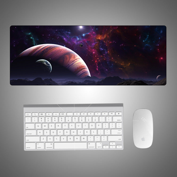 Space-themed desk mat with keyboard and mouse on a gray background